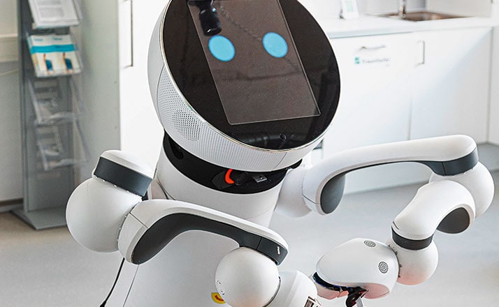 Mithilfe spezieller Greifarme schneidet Roboter „Care-O-bot“ Essen in einem Pflegeheim zu.